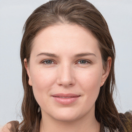 Joyful white young-adult female with long  brown hair and grey eyes