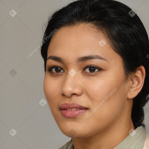 Joyful latino young-adult female with medium  brown hair and brown eyes