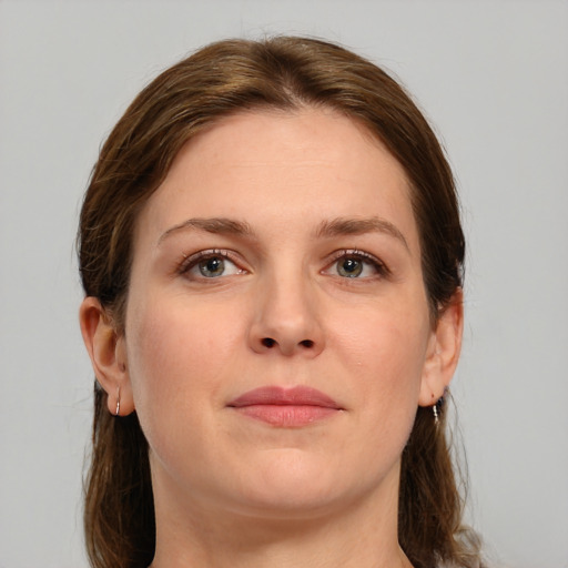 Joyful white young-adult female with medium  brown hair and grey eyes