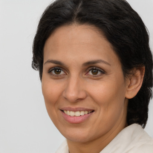 Joyful white adult female with medium  brown hair and brown eyes