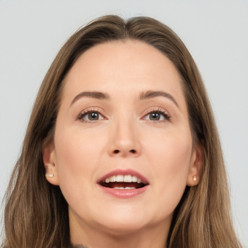 Joyful white young-adult female with long  brown hair and brown eyes