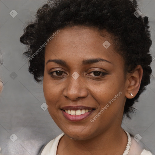 Joyful black young-adult female with short  brown hair and brown eyes