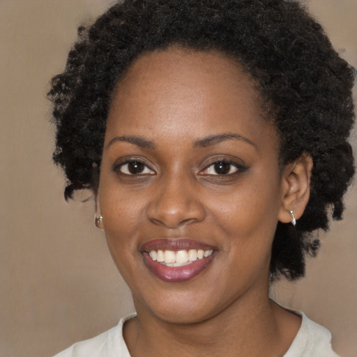 Joyful black young-adult female with short  brown hair and brown eyes