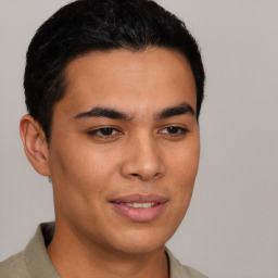 Joyful latino young-adult male with short  brown hair and brown eyes