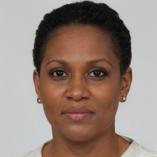 Joyful black adult female with short  brown hair and brown eyes