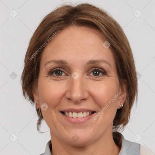 Joyful white adult female with medium  brown hair and grey eyes