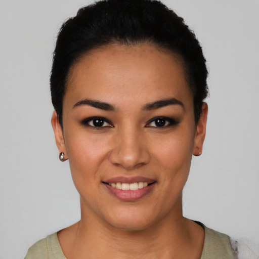 Joyful latino young-adult female with short  black hair and brown eyes