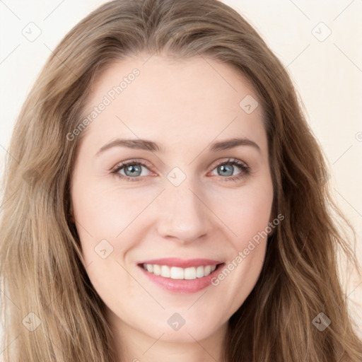 Joyful white young-adult female with long  brown hair and blue eyes