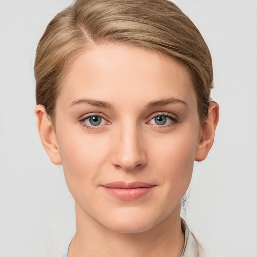 Joyful white young-adult female with medium  brown hair and grey eyes