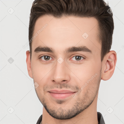 Joyful white young-adult male with short  brown hair and brown eyes