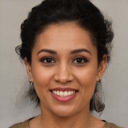 Joyful latino young-adult female with medium  brown hair and brown eyes