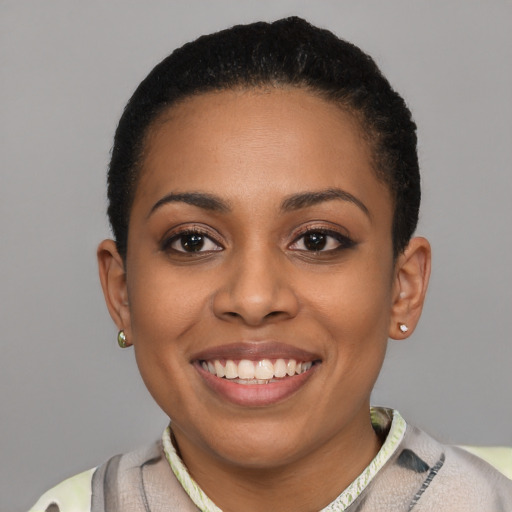 Joyful latino young-adult female with short  brown hair and brown eyes