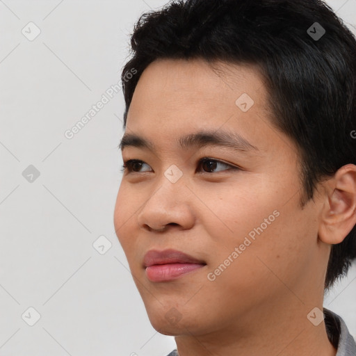 Joyful asian young-adult male with short  black hair and brown eyes