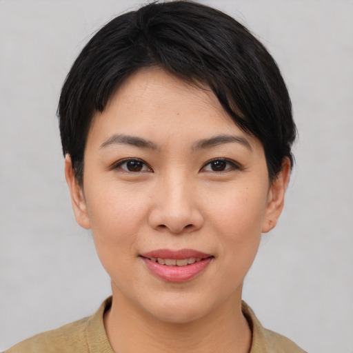 Joyful asian young-adult female with short  black hair and brown eyes