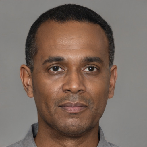 Neutral latino adult male with short  black hair and brown eyes