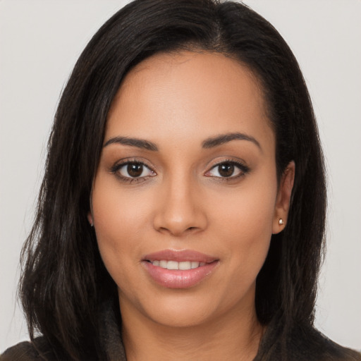 Joyful latino young-adult female with long  brown hair and brown eyes