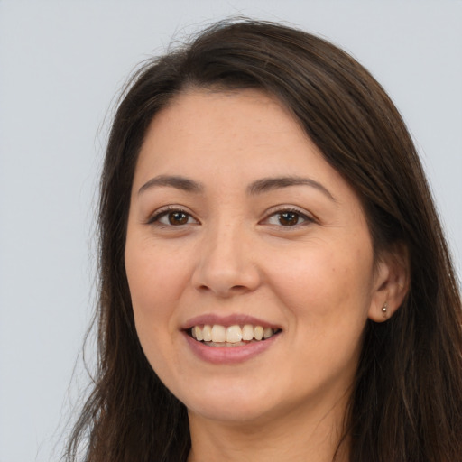 Joyful white young-adult female with long  brown hair and brown eyes