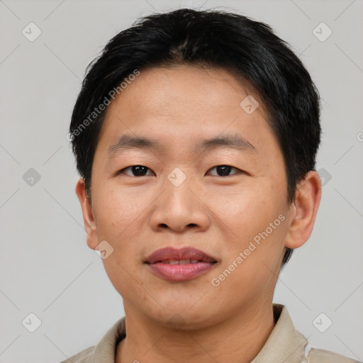 Joyful asian adult male with short  black hair and brown eyes