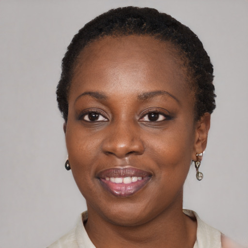 Joyful black young-adult female with short  black hair and brown eyes