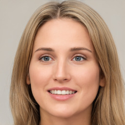 Joyful white young-adult female with long  brown hair and green eyes