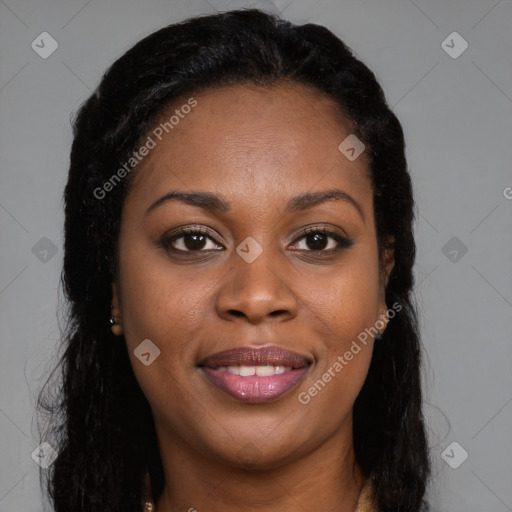 Joyful black young-adult female with long  brown hair and brown eyes