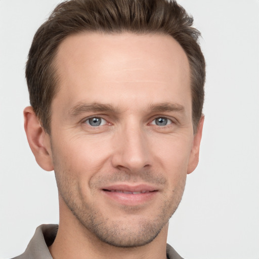 Joyful white adult male with short  brown hair and grey eyes