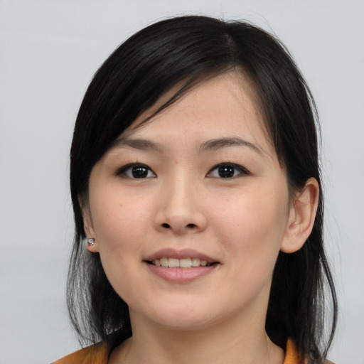 Joyful asian young-adult female with medium  black hair and brown eyes