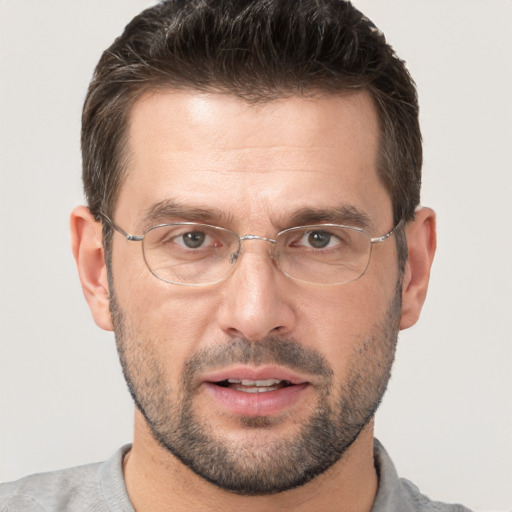 Joyful white adult male with short  brown hair and brown eyes