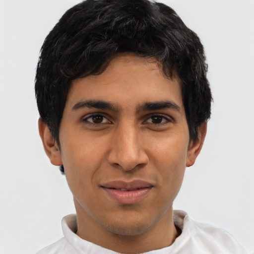 Joyful latino young-adult male with short  brown hair and brown eyes