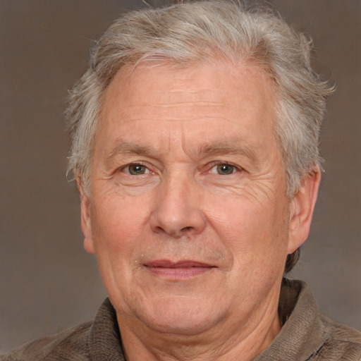 Joyful white middle-aged male with short  gray hair and brown eyes