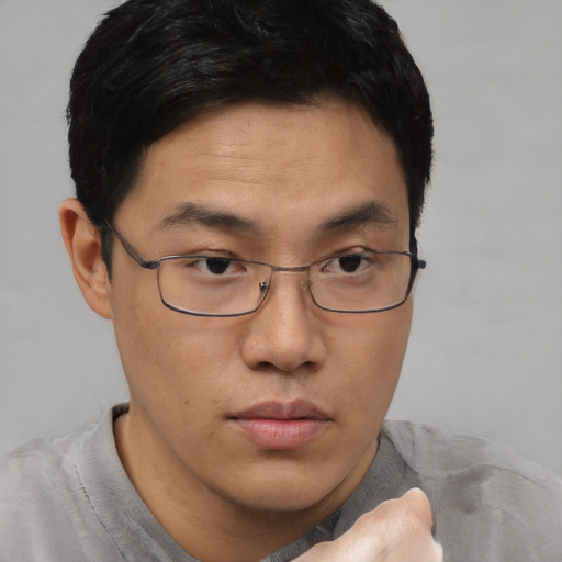 Neutral asian young-adult male with short  brown hair and brown eyes