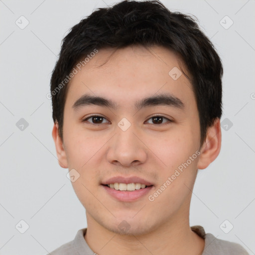 Joyful asian young-adult male with short  brown hair and brown eyes