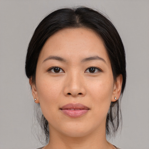 Joyful white young-adult female with medium  black hair and brown eyes