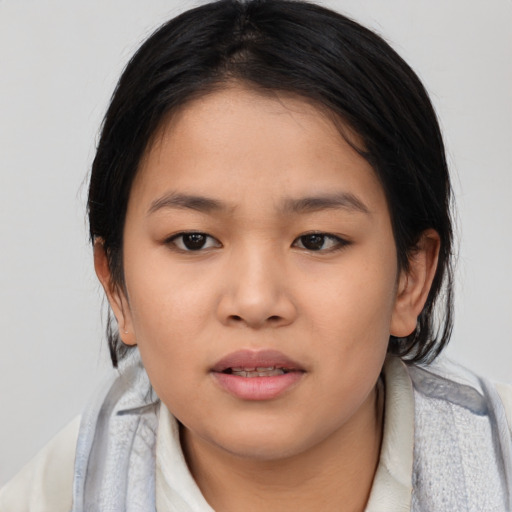 Joyful asian child female with medium  black hair and brown eyes