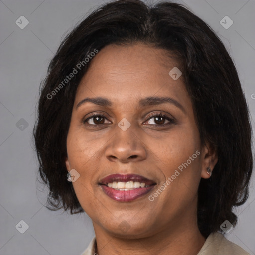 Joyful black adult female with medium  brown hair and brown eyes