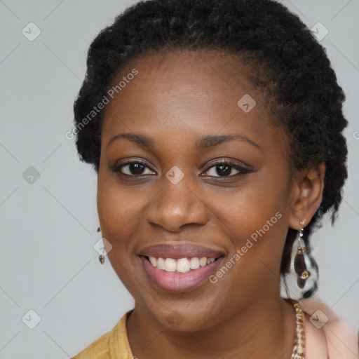 Joyful black young-adult female with long  brown hair and brown eyes