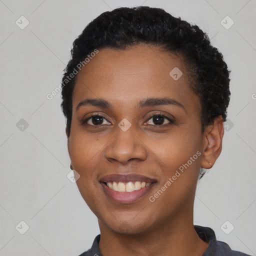 Joyful black young-adult female with short  black hair and brown eyes