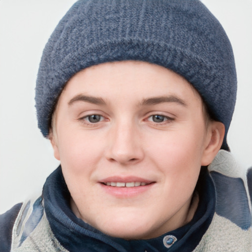 Joyful white young-adult female with short  brown hair and blue eyes