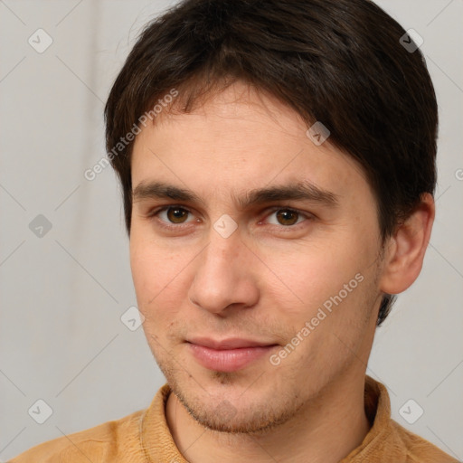 Joyful white young-adult male with short  brown hair and brown eyes