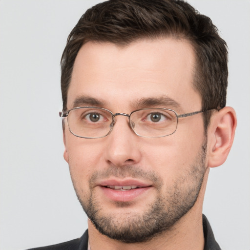 Joyful white adult male with short  brown hair and brown eyes