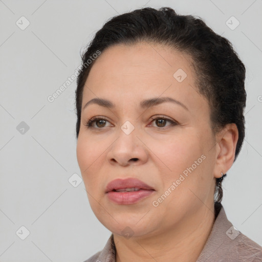 Joyful latino adult female with short  brown hair and brown eyes