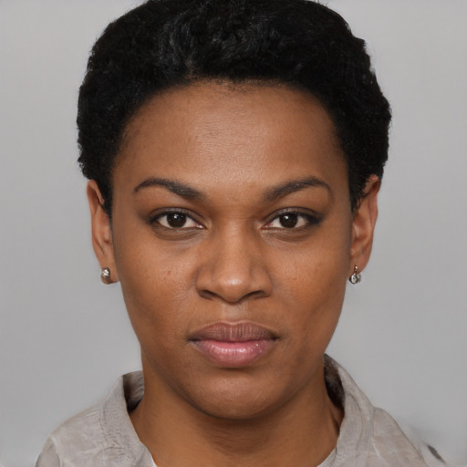 Joyful black young-adult female with short  black hair and brown eyes