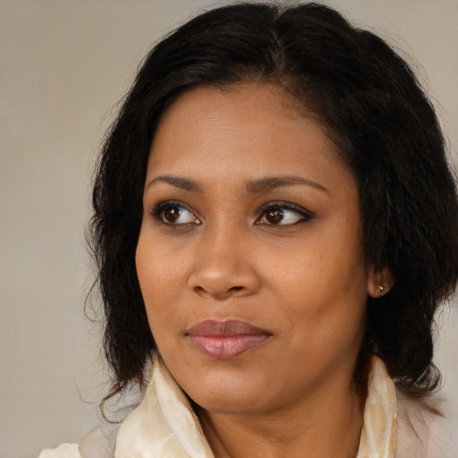 Joyful black young-adult female with medium  brown hair and brown eyes