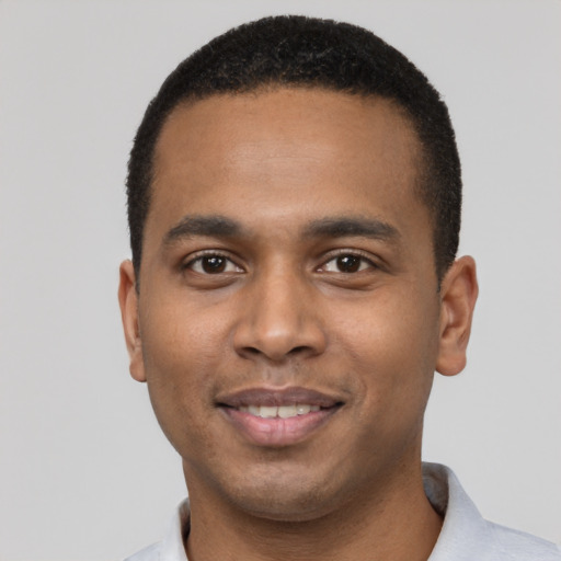 Joyful black young-adult male with short  black hair and brown eyes