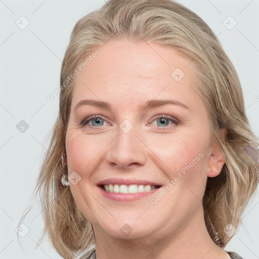 Joyful white young-adult female with medium  brown hair and blue eyes