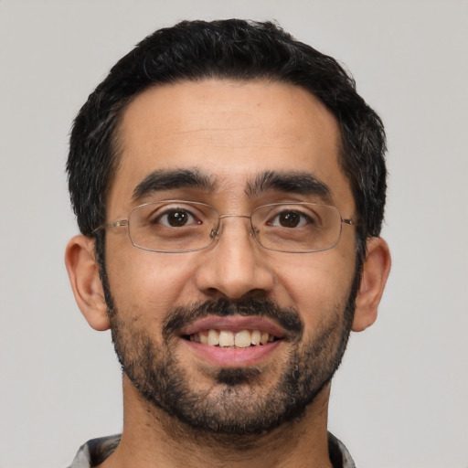 Joyful latino young-adult male with short  black hair and brown eyes