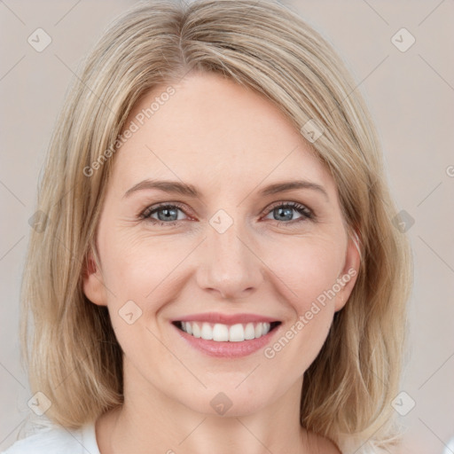 Joyful white young-adult female with medium  brown hair and blue eyes