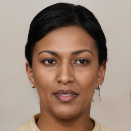 Joyful latino young-adult female with short  black hair and brown eyes