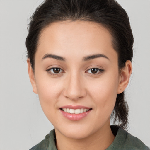 Joyful white young-adult female with long  brown hair and brown eyes