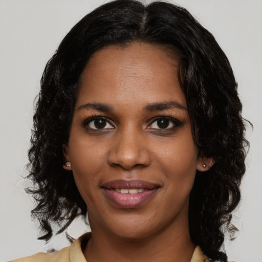 Joyful black young-adult female with medium  black hair and brown eyes